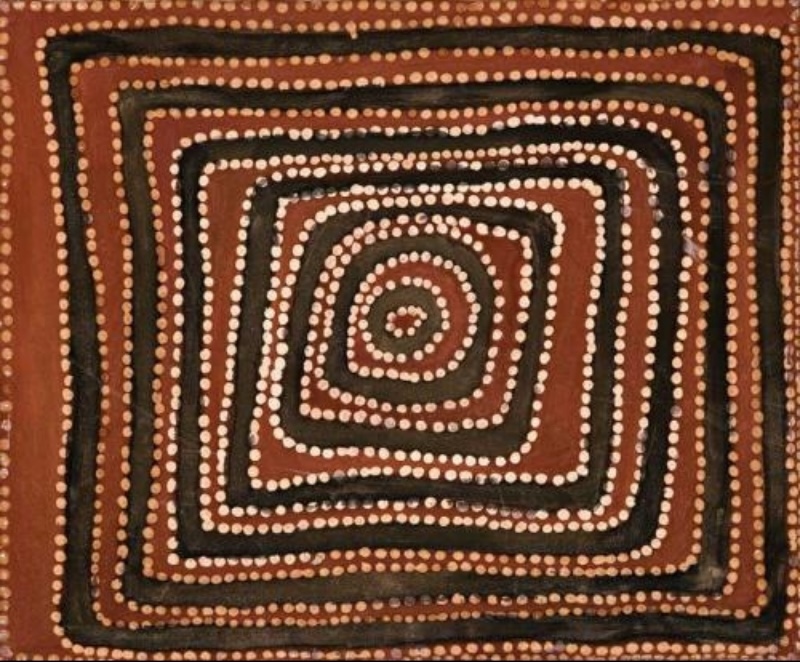 Rover Thomas painting of nested rectangular and circular forms in black and reddish-brown ochre. Thick black bands form a series of uneven rectangles that decrease toward the centre, ending in a small black circle. Closely spaced white dots outline every black band and form repeated rings around the central circle.