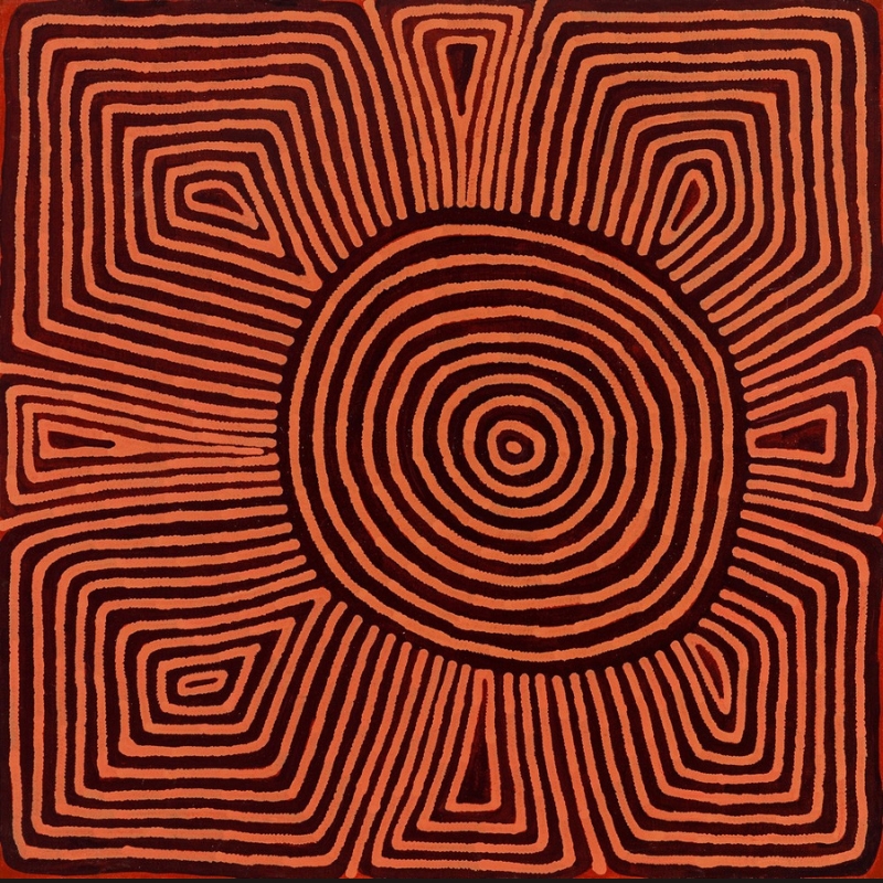 Ronnie Tjampitjinpa’s Moon Dreaming at Maanytja (1996), featuring a large central concentric circle surrounded by eight radiating geometric forms in alternating red and dark brown lines.