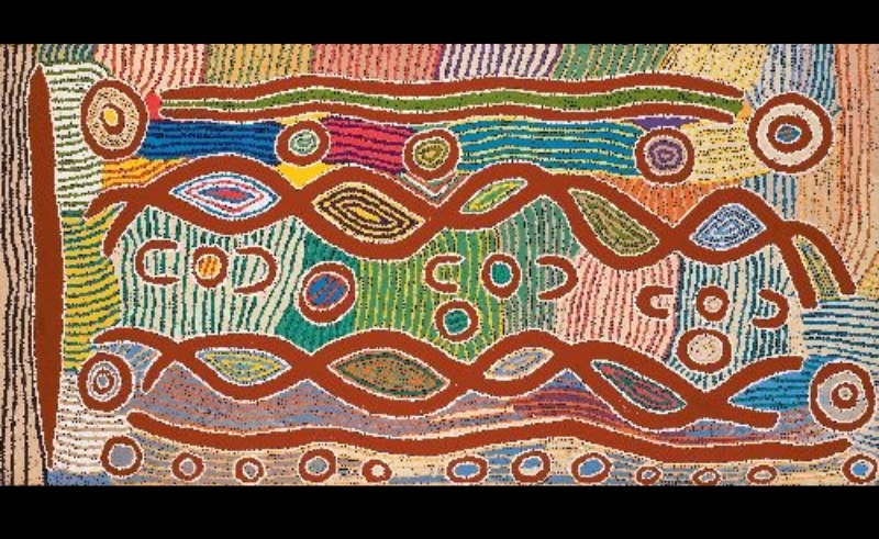 Maggie Watson Napangardi painting with long red interlocking forms, concentric circles and repeated oval motifs surrounded by dense bands of green, blue, pink, orange and white dots.
