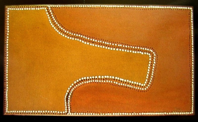 Rover Thomas painting in golden yellow and burnt orange ochre, divided by a broad winding line that curves from the top edge, bends across the centre and turns toward the bottom. Parallel rows of white dots and dark brown marks follow the winding boundary, with white dots also framing the rectangular canvas.