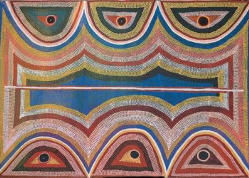 Boxer Milner’s Sturt Creek (1999), with repeated concentric forms and circular centres arranged around a broad blue central field in pink, ochre, green, red, white and black.