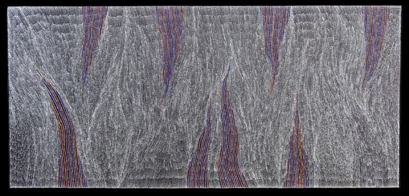Abstract painting of thousands of tiny black and white dots on a pale background. Broad vertical bands of red, blue and yellow rise through the composition, dividing fields of fine flowing dotting that resemble rolling desert sandhills.