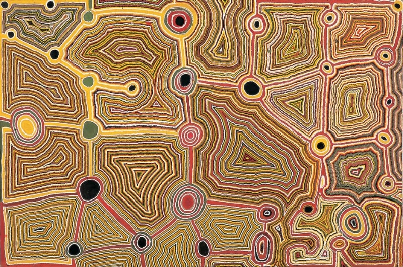 Tjumpo Tjapanangka Artist's Country c. 1989, with interconnected circles and densely layered geometric forms in ochre, yellow, red, black and white.