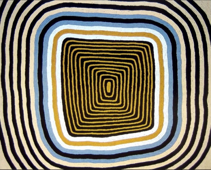 Ronnie Tjampitjinpa’s Moon Dreaming at Maanytja (1989), composed of nested rectangular bands radiating from a small central form in black, white, ochre and pale blue.