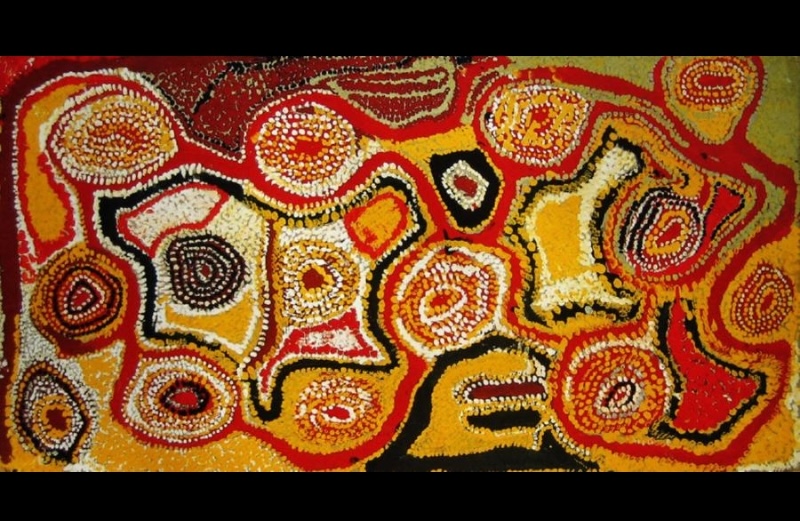 Wimmitji Tjapangarti's Wati Kutjarra (Two Men) at Nardu Diitji, 1992, with numerous concentric circular forms and irregular shapes linked across a densely painted field of red, yellow, orange, white and black.