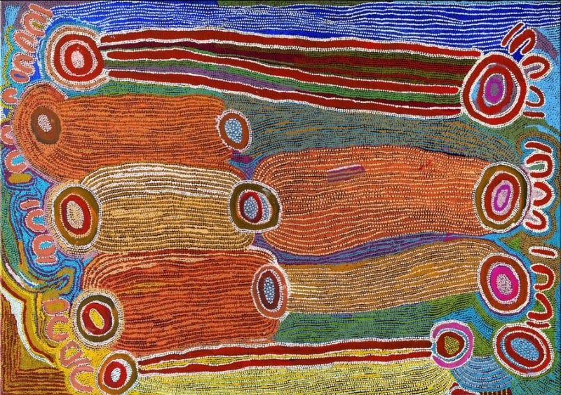 Maggie Watson Napangardi painting with large elongated ochre and orange forms linked by concentric circles, surrounded by dense bands of blue, green, red, pink, yellow and white lines.