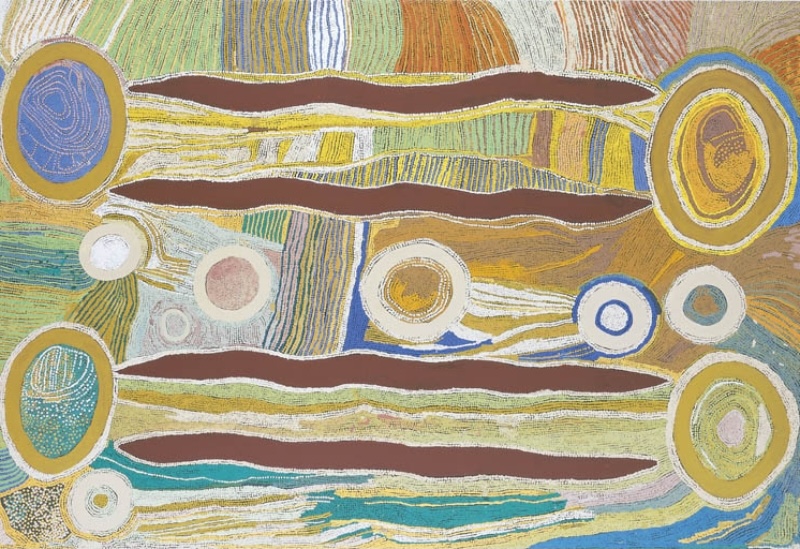 Maggie Watson Napangardi painting with long red-ochre digging-stick forms, large circular waterhole motifs and flowing fields of fine blue, yellow, green, cream and ochre lines.