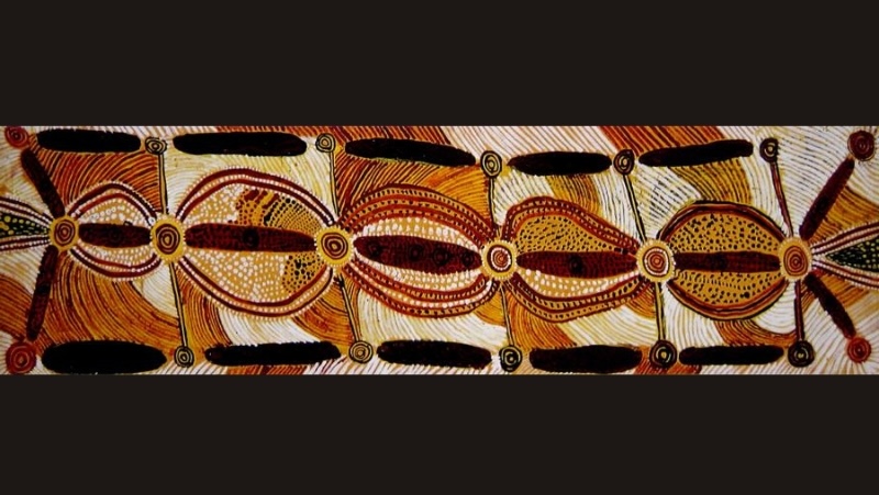 Ronnie Tjampitjinpa’s Untitled (1972), a long horizontal Papunya painting with repeated concentric circles, oval forms, connecting lines and black elongated motifs surrounded by dense red, yellow, white and ochre linear patterning.