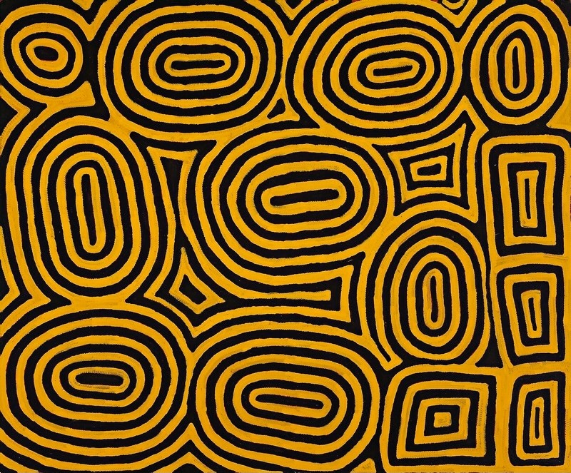 Ronnie Tjampitjinpa’s Tingari Cycle (1997), featuring large interlocking oval and rectangular forms made from bold concentric yellow and black bands across the canvas.