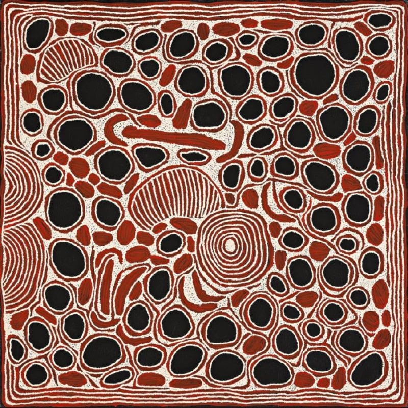 Square red, black and white Aboriginal painting by Ningura Napurrula densely filled with irregular black ovals outlined in white and smaller red forms. A large concentric circle appears near the lower centre, with several striped semicircular and comb-like shapes nearby, while repeated red and white lines form a border around the composition.