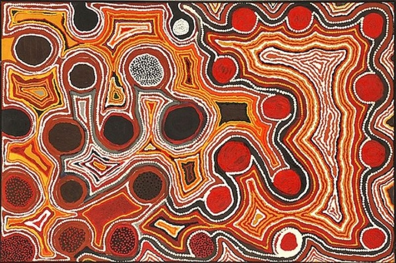 Tjumpo Tjapanangka Kangaroo Dreaming 1994, with red, black and brown circular forms surrounded by winding white, yellow and ochre lines.