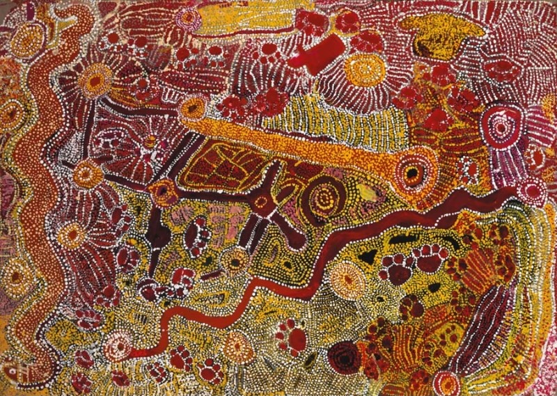 Wimmitji Tjapangarti's Dingo and Rainbow Snake Dreaming, with winding red ancestral pathways, dingo paw-print forms, circular sites and dense red, yellow, white and black dotting.