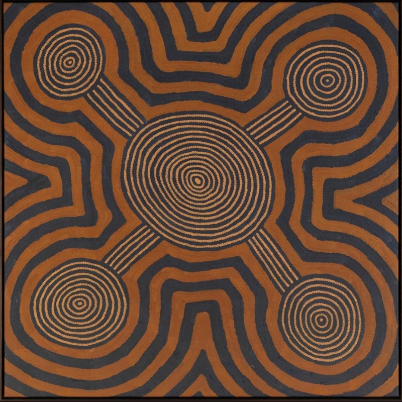 Ronnie Tjampitjinpa’s Water Dreaming at Maparrinya (1991), featuring a large central concentric circle connected by parallel lines to four smaller circular forms, surrounded by bold black and ochre geometric bands.