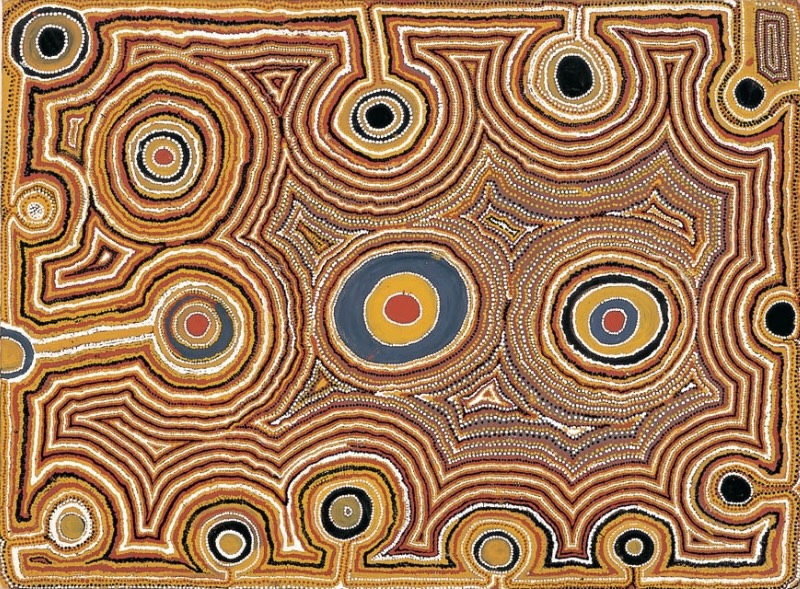 Tjumpo Tjapanangka Untitled 1988 painting with concentric circles, interconnected ochre lines and dense white dotting on a black, brown, yellow and red ground.