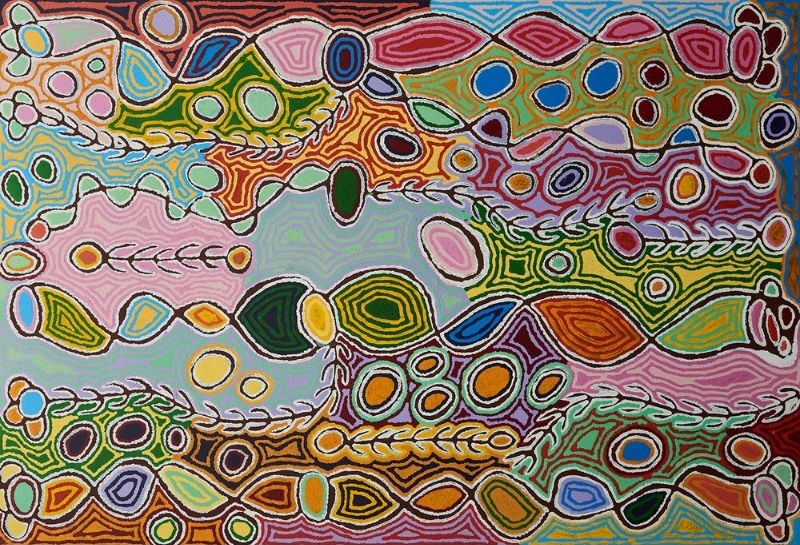 Colourful Aboriginal painting by Judy Napangardi Watson filled with interlocking oval and leaf-like forms, branching lines, circles and flowing bands in pink, green, red, orange, blue and white.