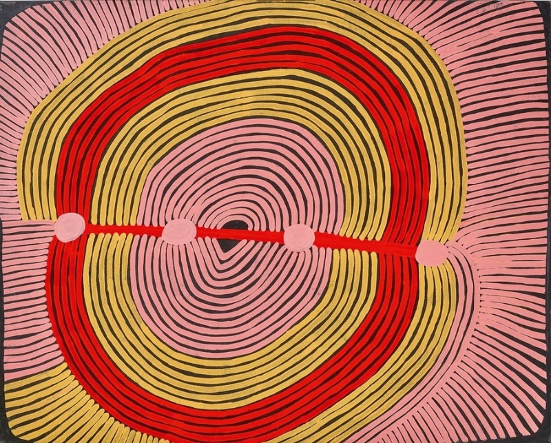Ronnie Tjampitjinpa’s Eagle Dreaming (1995), featuring sweeping concentric bands of pink, yellow, red and black crossed by a horizontal red line connecting four pale pink circular forms.