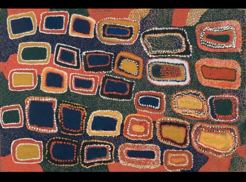 Boxer Milner’s Purkitji (2003), showing rows of irregular rectangular forms outlined with dots in white, red, yellow and orange against dark blue, green and earthy fields.