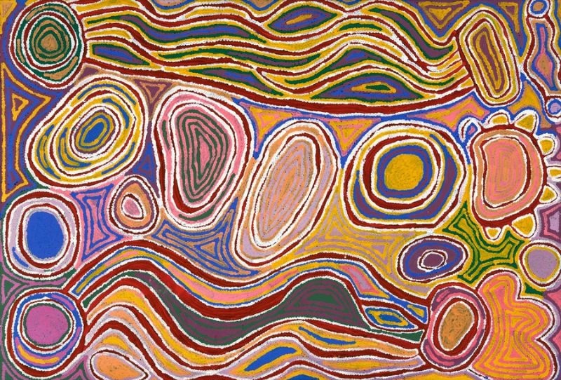 olourful Aboriginal painting by Judy Napangardi Watson with large concentric oval and circular forms surrounded by sweeping, rippling bands of red, green, yellow, pink, blue and white.