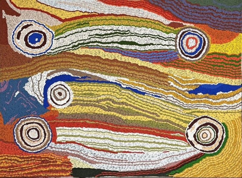 Maggie Watson Napangardi painting with large concentric circles linked by elongated forms, surrounded by flowing bands of yellow, green, blue, red, brown and white dots.