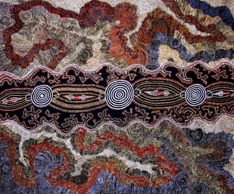 Maggie Watson Napangardi painting with three bold black-and-white concentric circles linked across a dark central band, surrounded by densely dotted winding forms in red, blue, grey, ochre and white.
