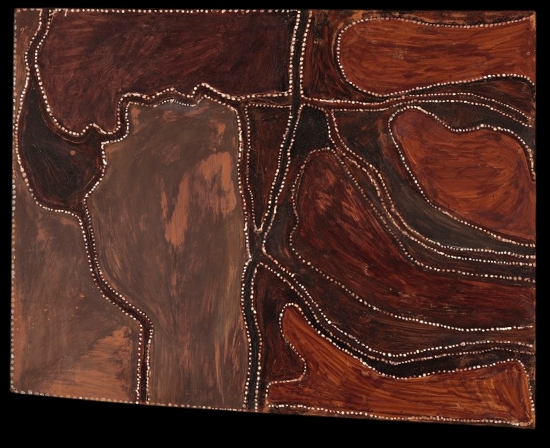 Rover Thomas ochre painting with irregular brown and black areas divided by winding pathways and boundaries outlined with rows of small white dots.