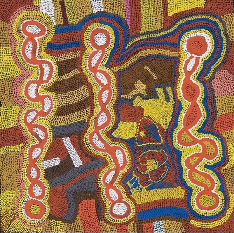 Maggie Watson Napangardi painting with three tall red winding forms outlined in white, yellow and blue, set against dense fields of yellow, brown, red, pink and black dotting.