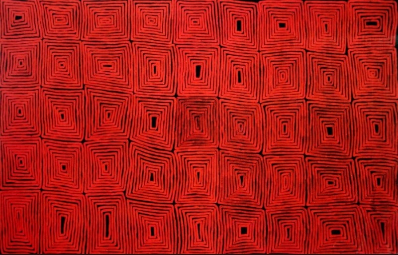 Ronnie Tjampitjinpa’s Tingari Cycle (1997), featuring a dense grid of repeated nested rectangular forms painted in vivid red and black across the entire canvas.