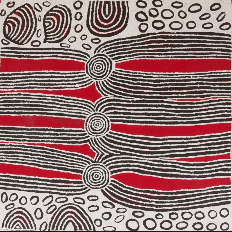Square red, black and white Aboriginal painting by Ningura Napurrula dominated by three concentric circles arranged vertically down the centre. Broad horizontal bands of black and white parallel lines extend from the circles across vivid red fields, while outlined oval shapes and large striped semicircular forms fill the upper and lower edges.