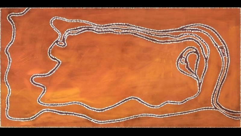 Rover Thomas ochre painting with a large orange field crossed and enclosed by winding parallel rows of white dots, with a small looped form at right.