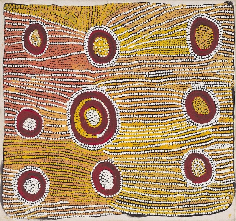 Maggie Watson Napangardi painting with red circular motifs surrounded by flowing rows of white, yellow, ochre and orange dots across a square canvas.