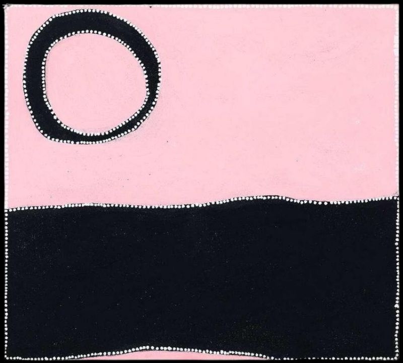Minimalist Aboriginal painting divided into two horizontal fields. The upper half is soft pink with a single large black ring in the upper left corner enclosing a pink centre. The lower half is a broad solid black band that spans the width of the painting. Fine white dots outline the ring, the dividing line and the outer border, creating strong contrast between the black and pink areas.