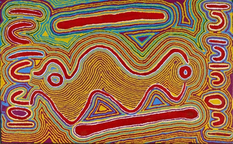 Judy Watson Napangardi painting from 2000 with a large central undulating ochre form, long red bars and U-shaped motifs surrounded by dense lines of yellow, green, blue, red and white.