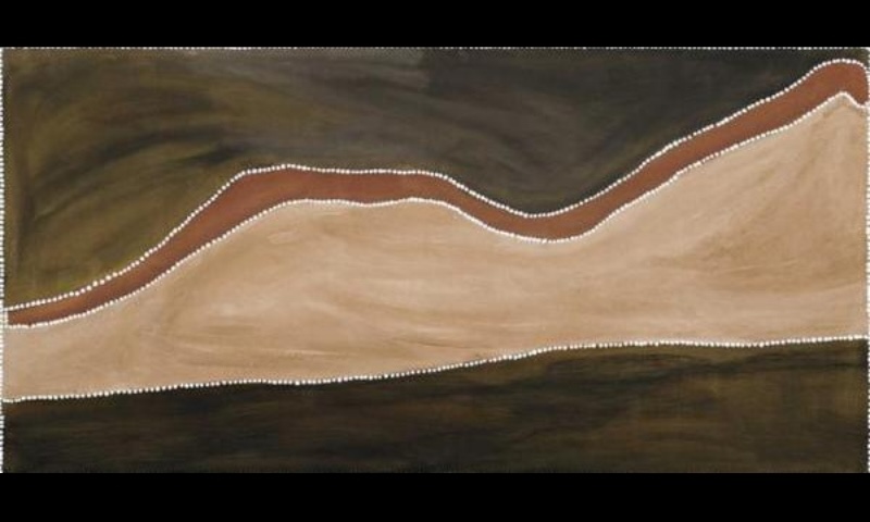 Rover Thomas ochre painting with a broad pale cream salt pan sweeping across dark brown and black fields, edged by a narrow red-brown band and rows of white dots.