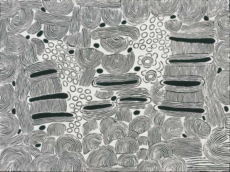 Large black and white Aboriginal painting by Ningura Napurrula filled with dense fine lines forming rounded hills, curved bands and stacked horizontal shapes. Clusters of small outlined circles and scattered black forms run through the centre, while two concentric circles with adjoining U-shaped motifs appear near the upper right.