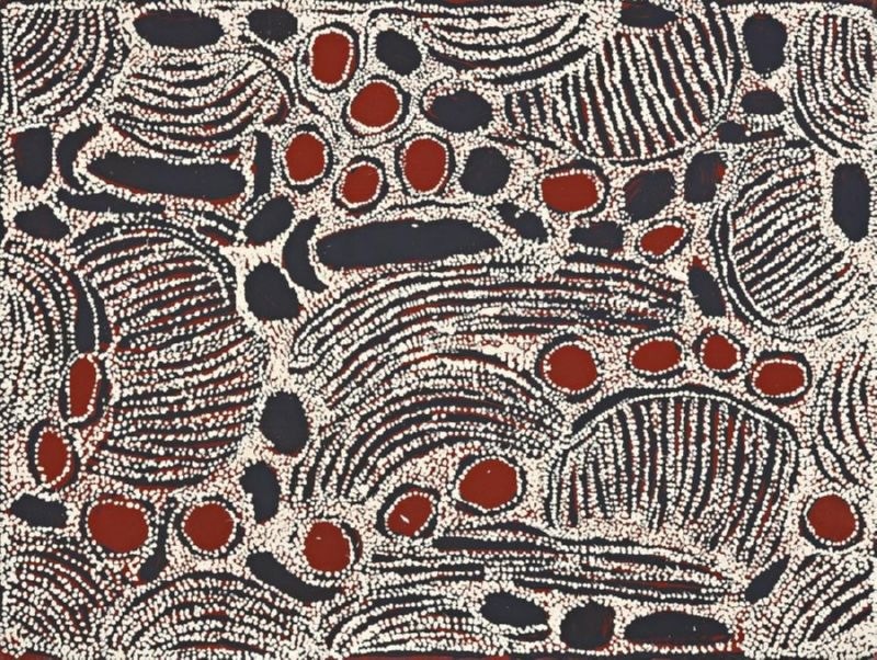 Black, white and deep red Aboriginal painting by Ningura Napurrula densely filled with curved bands, elongated oval forms and clusters of red and black shapes. Fine white dotted lines form repeated arcs and striped semicircular patterns across the dark ground, with a large sweeping curved form dominating the centre.