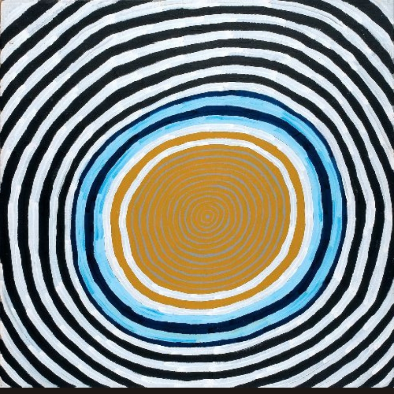 Ronnie Tjampitjinpa Moon Dreaming 2003 painting, featuring a large circular design of concentric black, white, blue and ochre rings radiating from a central ochre disc.