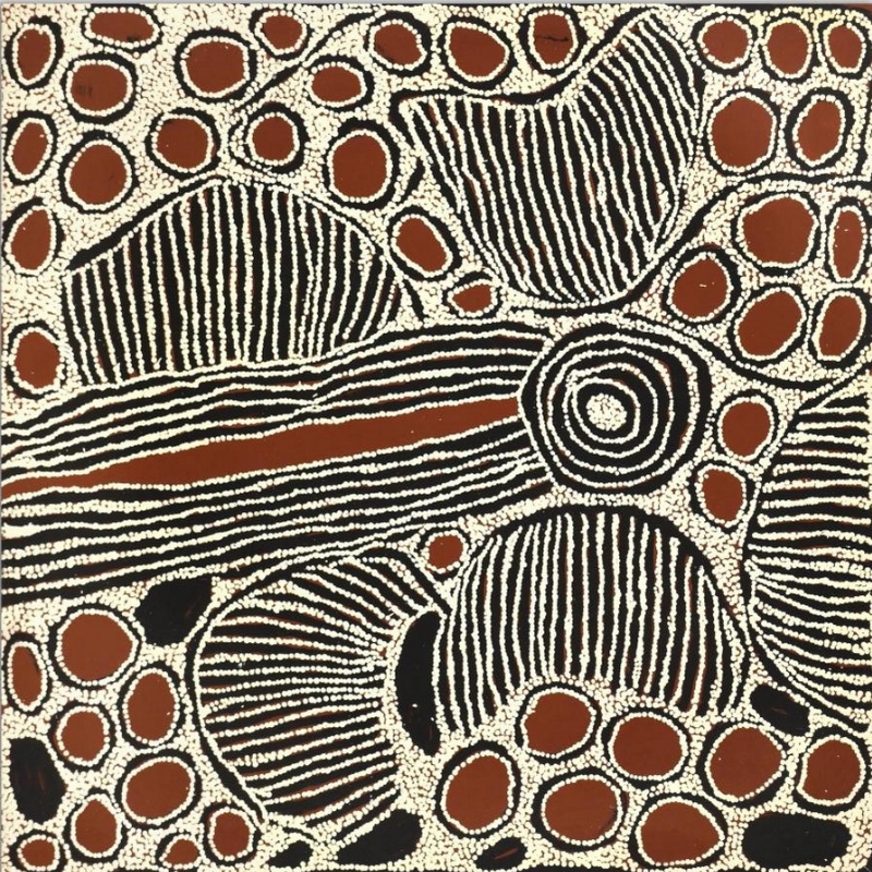 Square black, white and reddish-brown Aboriginal painting by Ningura Napurrula centred on a large concentric circle connected to a long horizontal band of parallel white lines. Large striped semicircular and rounded forms surround it, while numerous reddish-brown ovals outlined with white dots cluster densely across the upper and lower areas of the painting.