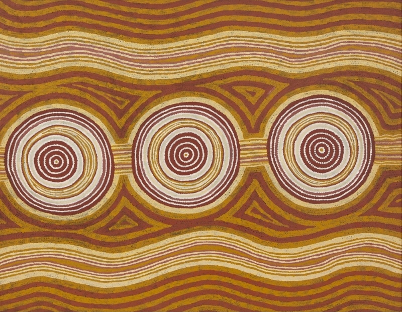 Turkey Tolson Tjupurrula Straightening Spears at Ilyingaugau, 1991. Aboriginal painting with three large concentric circles linked by horizontal wavy bands in ochre, cream, pink and brown across the canvas.