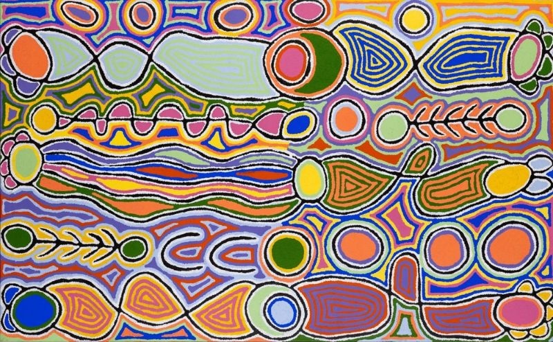 Aboriginal painting by Judy Napangardi Watson filled with brightly coloured interconnected oval, circular and elongated forms, wavy bands and linear motifs outlined in black and white against a pale blue ground.