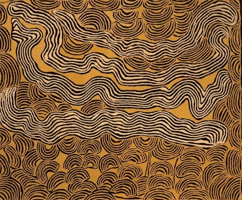 Ochre and black Aboriginal painting by Ningura Napurrula filled with dense parallel lines. Long undulating bands sweep horizontally across the centre, while repeated rounded and semicircular forms made from nested curved lines cluster around the edges and across the lower part of the composition.