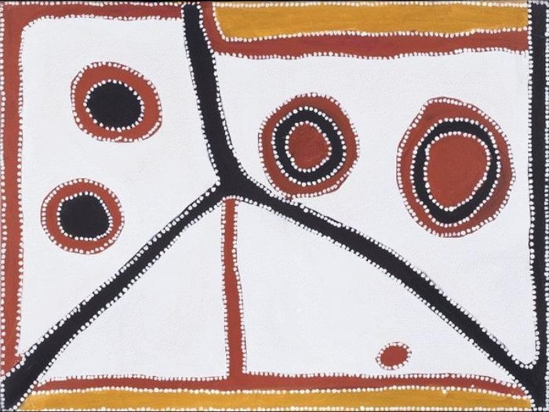 Abstract Aboriginal painting on a white background with black and reddish-brown lines dividing the composition into large geometric sections. Five circular motifs of different sizes are arranged across the upper half, each outlined with fine white dots. A broad black diagonal line sweeps from the centre toward the lower right, while ochre bands frame the top and bottom edges. The painting uses a restrained palette of white, black, reddish brown and ochre.
