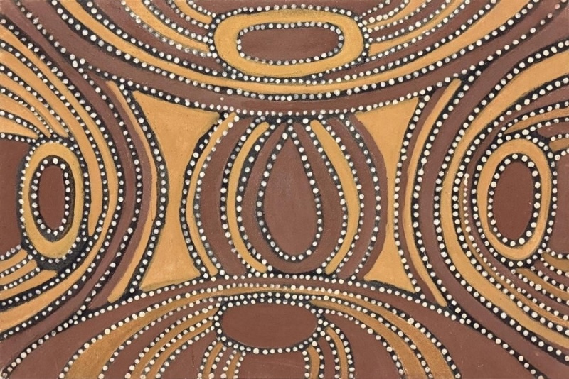Yarralullybine, 1997 by Jack Britten, with large oval and leaf-shaped forms surrounded by sweeping black, yellow and brown bands edged with white dots.