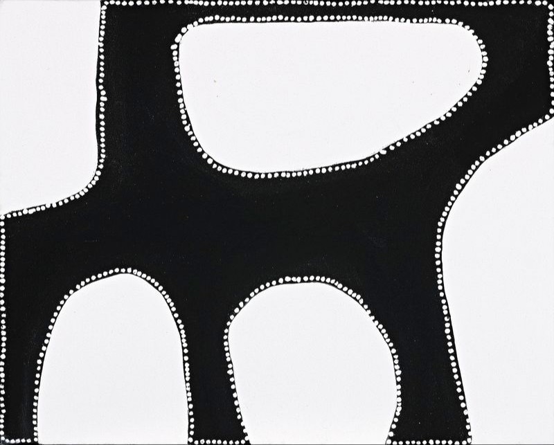 Minimalist Aboriginal painting with a pale cream background dominated by a single large black abstract form that spans almost the entire composition. The black shape contains three large rounded white openings and is outlined with fine white dots around both its outer edge and the internal shapes. The strong contrast between black and white creates a bold, sculptural appearance with broad areas of open space.