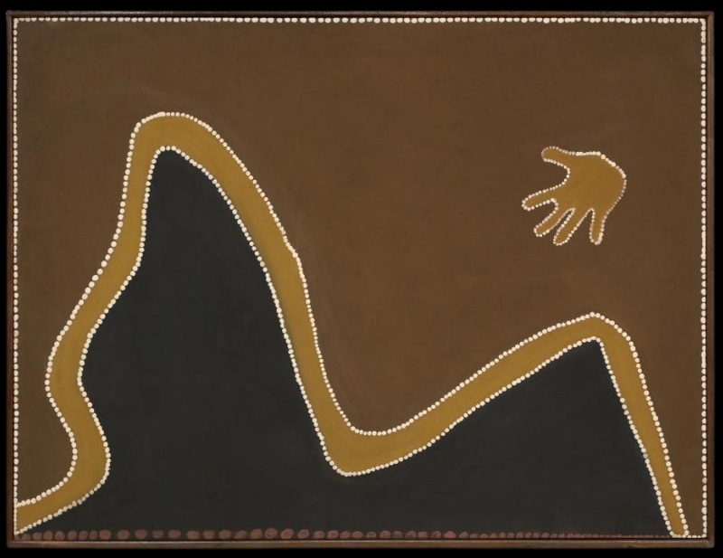 Rover Thomas painting with a large black mountain-like form rising in two peaks across the lower half of a brown ochre field. A golden ochre band edged with small white dots follows the peaks and valleys, while a small five-fingered hand-like shape floats in the upper right.