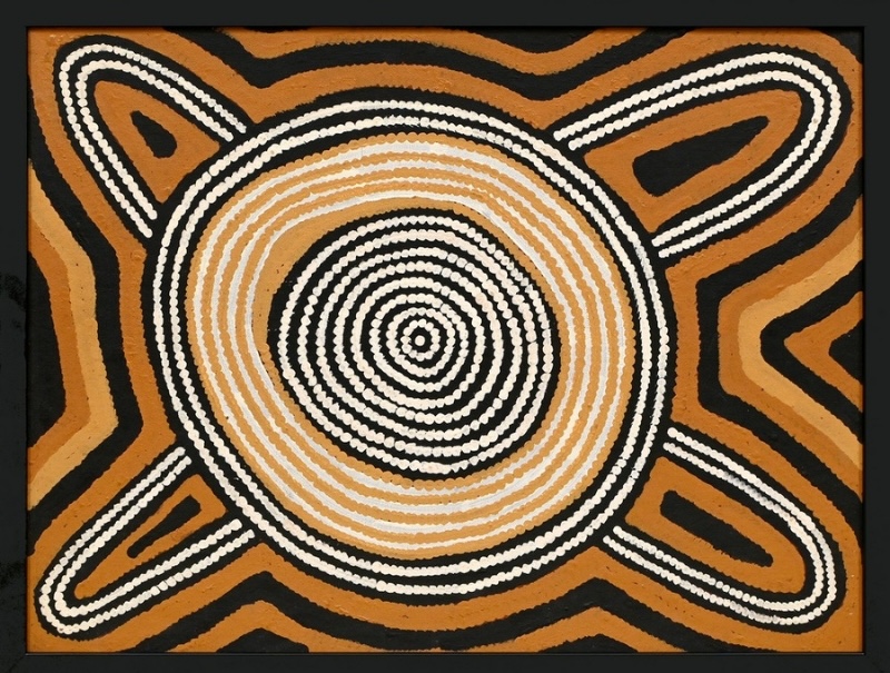 Ronnie Tjampitjinpa’s Untitled (Kaakaratintja – Lake MacDonald) (1992), featuring a large central concentric circle with four projecting oval forms, surrounded by bold black and ochre geometric bands and white dotted lines.
