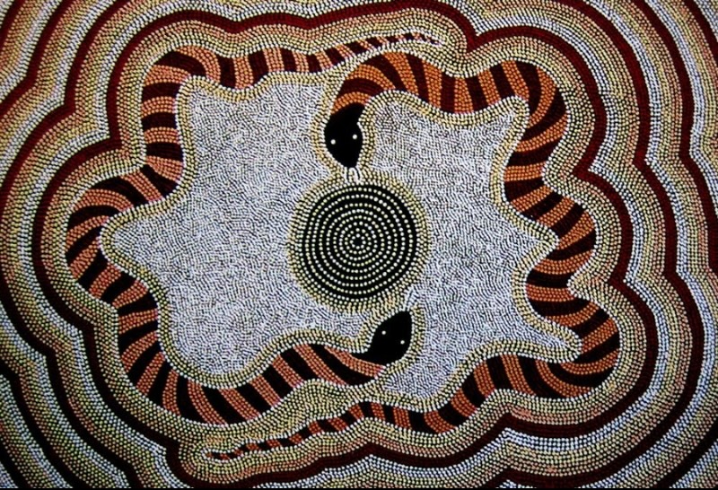 Turkey Tolson Tjupurrula Brown Snake Dreaming, 1982. Aboriginal painting showing a banded snake coiled around a central concentric circle, surrounded by flowing dotted bands in ochre, white, black and reddish-brown.