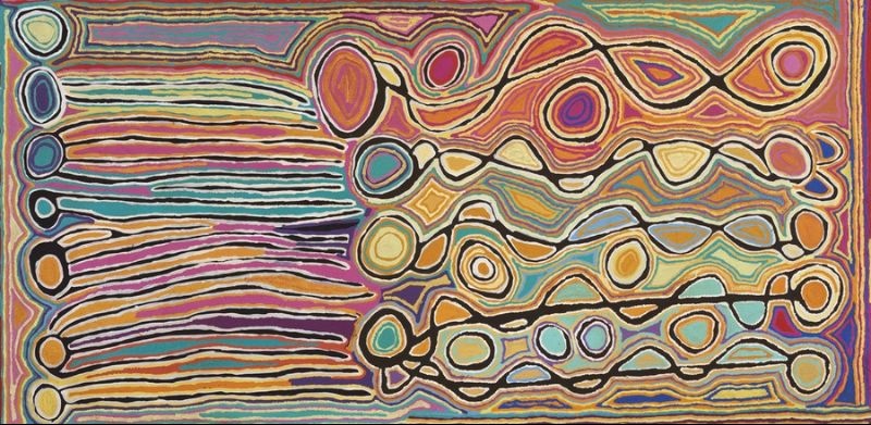 Long horizontal Judy Watson Napangardi painting with parallel bands and interlocking oval, circular and sinuous forms in ochre, pink, green, blue, cream and orange, outlined with dark lines.