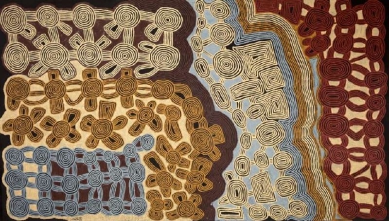 Ronnie Tjampitjinpa’s Tingari Cycle (1997), a monumental horizontal painting filled with networks of concentric circles, connecting lines, looped forms and geometric motifs in cream, brown, red and pale blue.