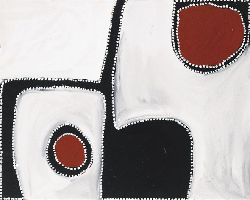 Abstract Aboriginal painting on a pale cream background with bold black shapes arranged around the edges. A narrow black vertical band divides the composition, while a large rounded black form occupies the lower right. Two deep reddish-brown circular motifs outlined in black appear in the upper right and lower left, creating strong focal points. Fine white dots trace every shape and the outer border, producing a balanced minimalist composition.