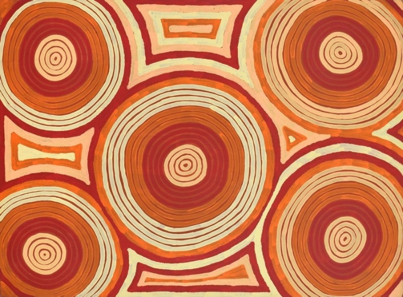 Ronnie Tjampitjinpa’s Tingari (1996), featuring five large concentric circular forms in red, orange and cream, separated by smaller rectangular and triangular geometric motifs.